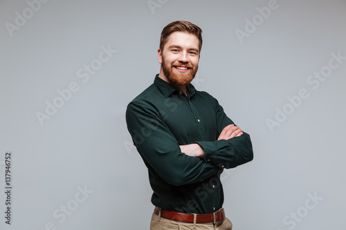Smiling Bearded man in shirt with crossed arms © Drobot Dean