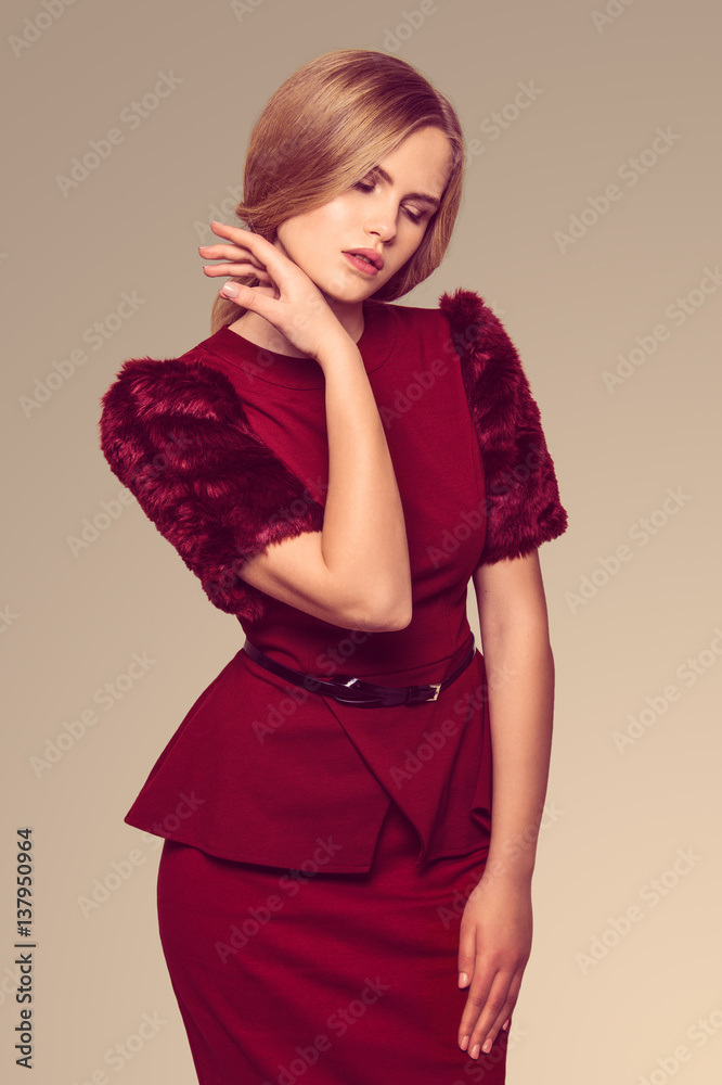 Fototapeta premium beautiful blonde woman posing in burgundy dress