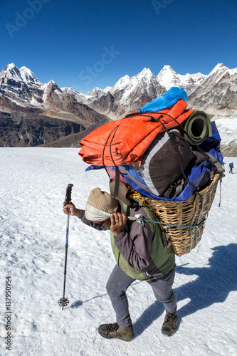 Nepalese Porter carrying Basket with Mountain Expedition Luggage
