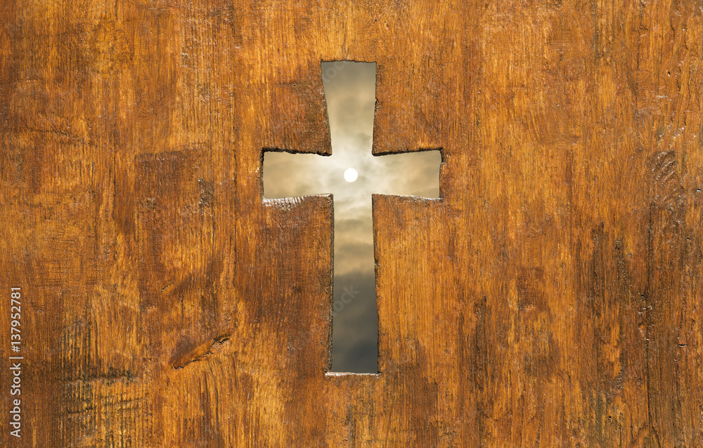Cross shape hole in a church wooden fence