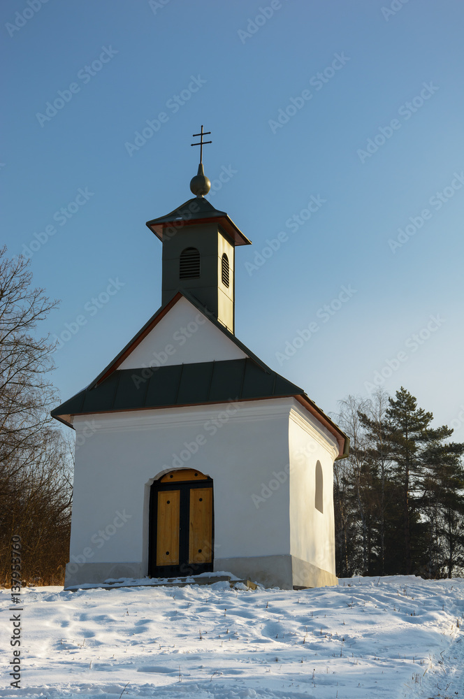 Little chapel in snowy landscape
