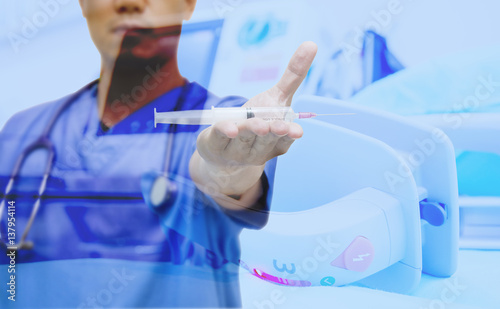 doctor show syring select focus of syringe and EKG monitor