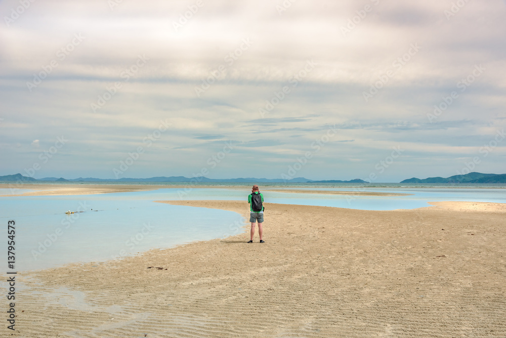 Man stand alone on a beach near El Nido, Palawan