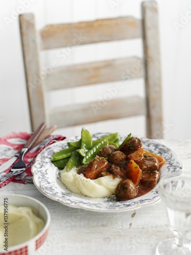 Beef and kidney stew with mashed potatoes and mange tout photo