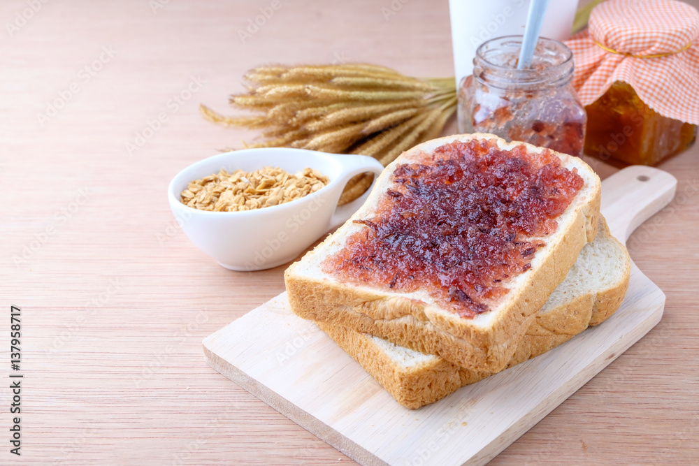 Bread with jam grape on wood background Bread with jam grape on wood background