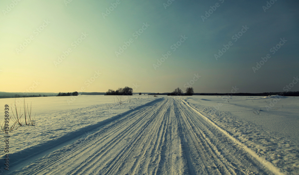 Winter road in the late evening at sunset Winter road in the late evening at sunset