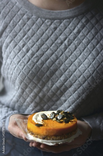 A vegan pumpkin cake with cashew cream and caramelised pumpkin seeds photo