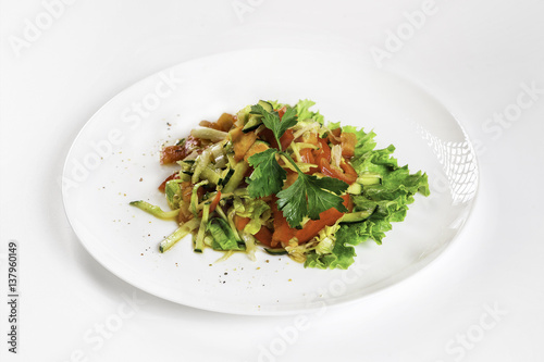 Plate of fresh vegetable salad isolated at white background.