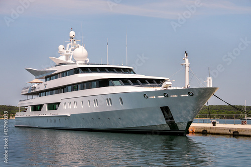 Large modern white yacht anchored in harbor © zoranlino