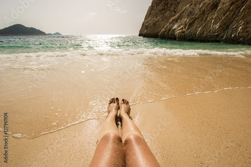 Fototapeta Naklejka Na Ścianę i Meble -  Legs on the beach. Turkey, Kas, Kaputas beach.
