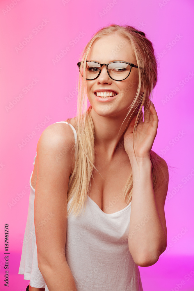 Beautiful woman wearing glasses posing over pink background. Beautiful woman wearing glasses posing over pink background.