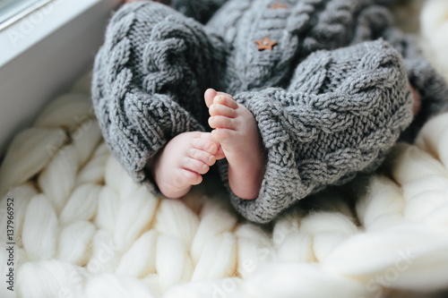 Small baby in knitted clothes