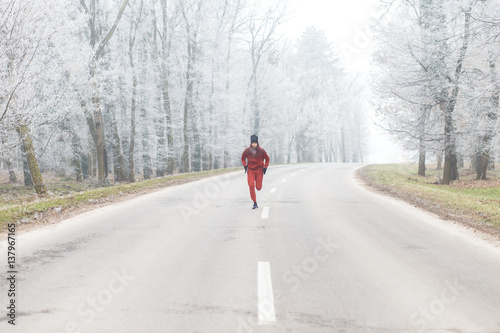 Young athletic man running on the road in winter. © Zoran Zeremski