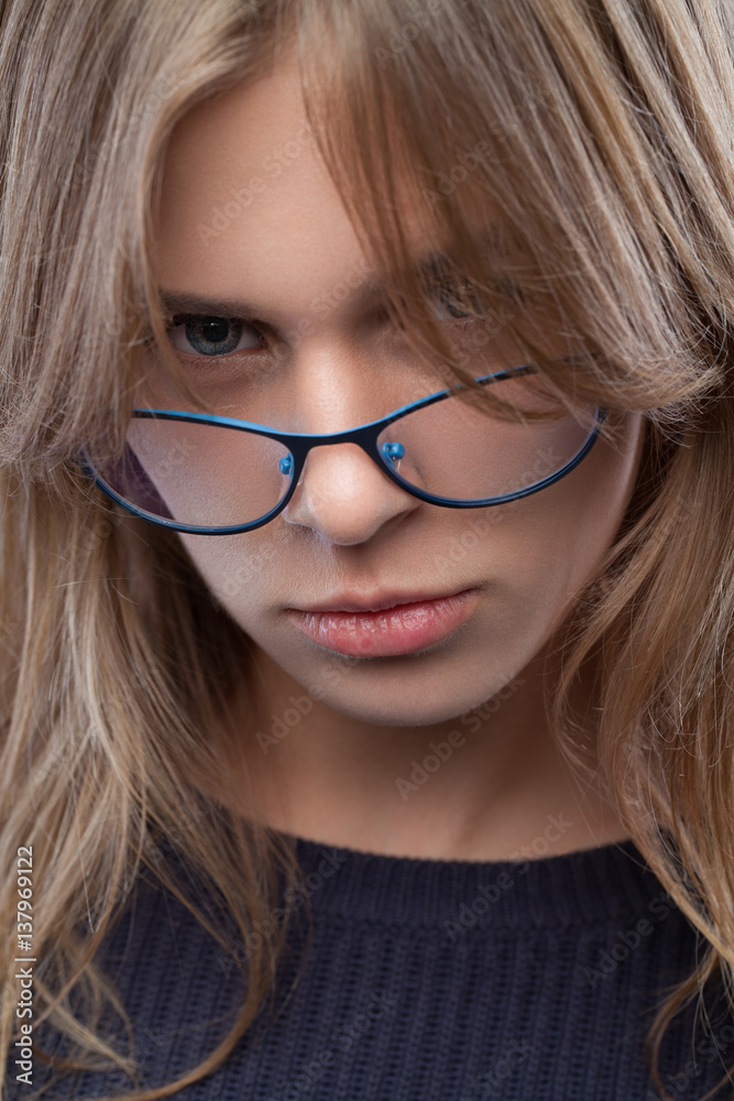 Closeup portrait of a young beautiful girl with glasses with natural makeup. Vogue style portrait. Closeup portrait of a young beautiful girl with glasses with natural makeup. Vogue style portrait.