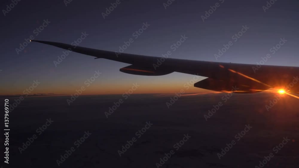 Clouds and beautiful sunrise. View from the window of an airplane wing, clouds and a beautiful sunrise. Clouds and beautiful sunrise. View from the window of an airplane wing, clouds and a beautiful sunrise.