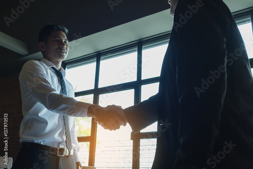 Businessmen handshake after successful negotiations.