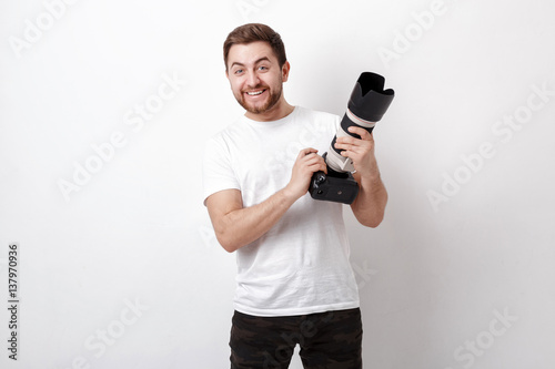 young smilling professional photographer in t-shirt use digital 