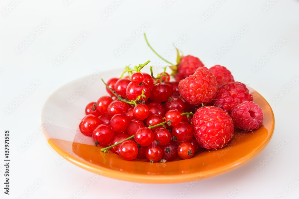 Berries red currants and raspberry on a plate Berries red currants and raspberry on a plate
