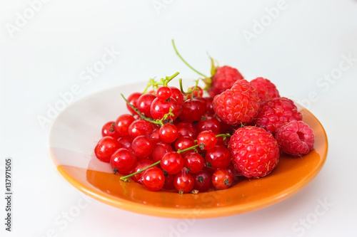 Berries red currants and raspberry on a plate