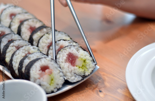 maki sushi rolls japan food on plate eating with foodsticks photo