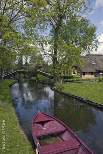 Giethoorn water village the Netherlands. Overijssel. Canals. Farmhouses. Wooden bridge. Boat.