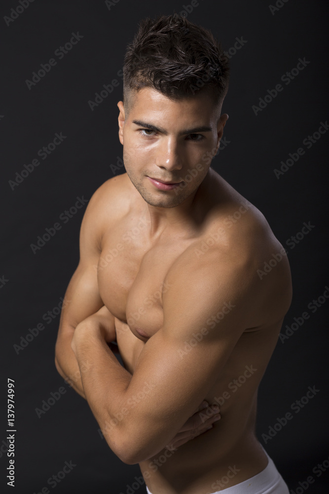 Handsome muscular young man posing in the studio