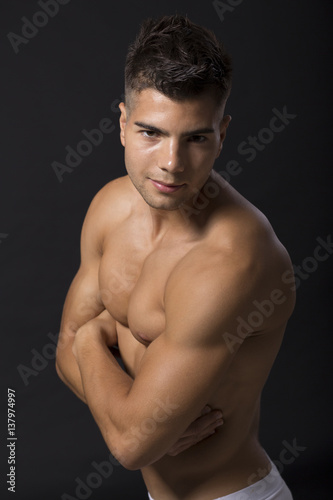 Handsome muscular young man posing in the studio