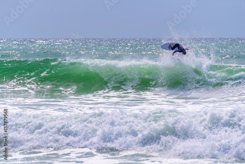 Surfer riding a huge wave during  World surf league competition in Lacanau, France © Delphotostock