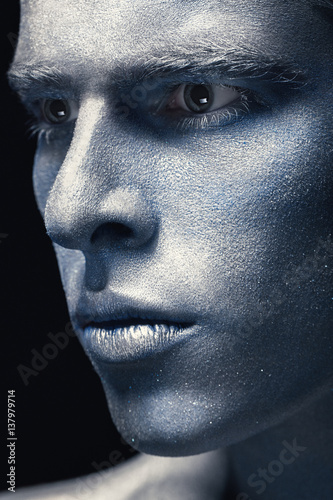 Portrait of man isolated at dark background. Art blue and grey Makeup. Skincare concept.