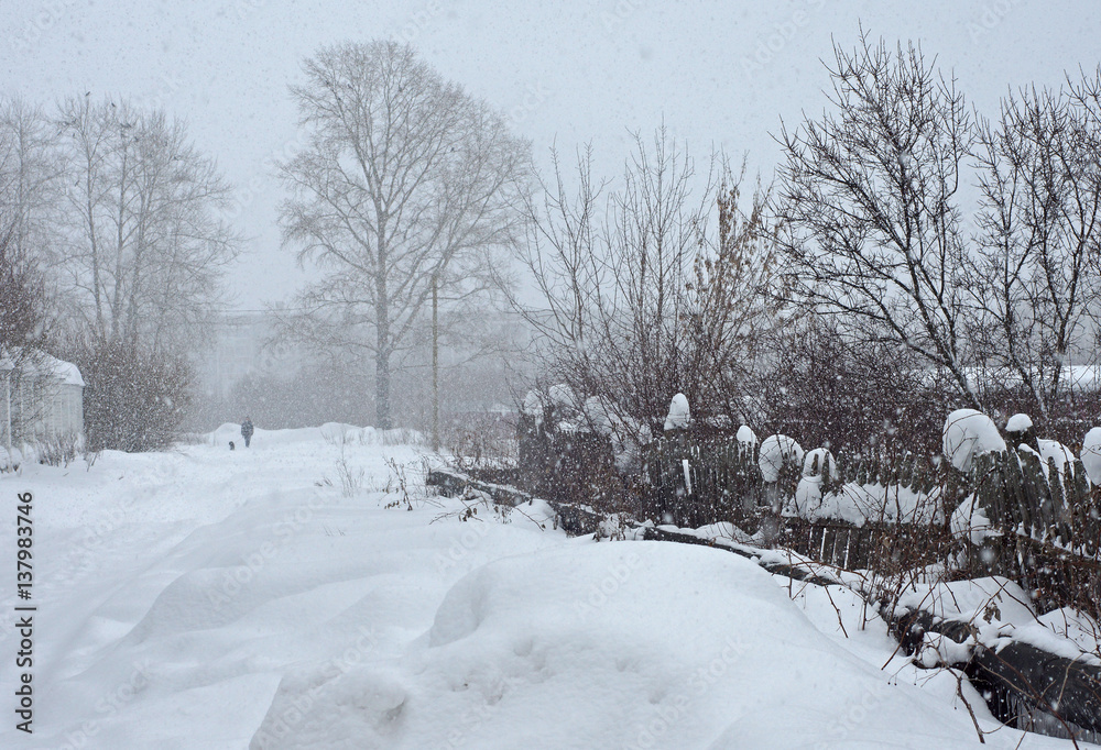 old wooden fence during a snowfall in winter old wooden fence during a snowfall in winter