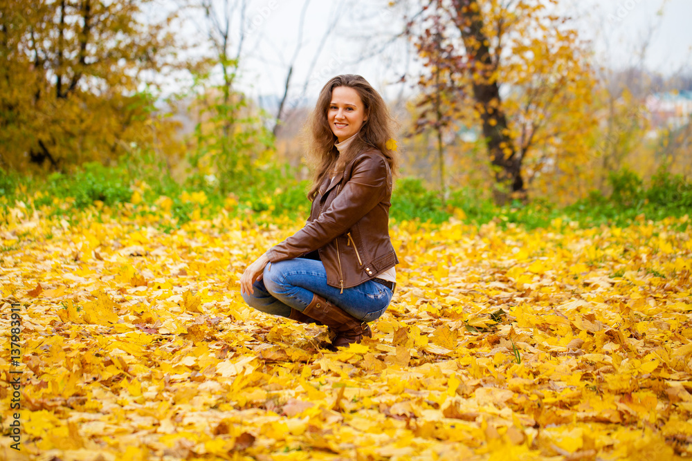 Autumn fashion image of young woman walking in the park Autumn fashion image of young woman walking in the park