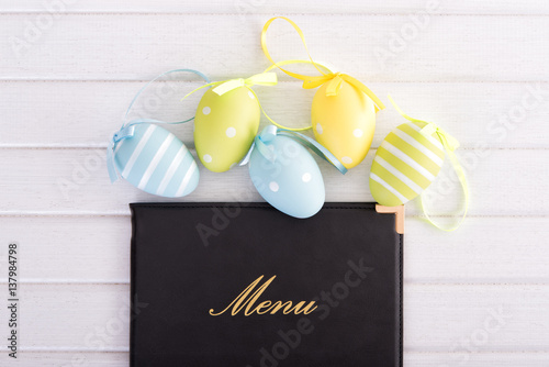 Menu with easter eggs on wooden table