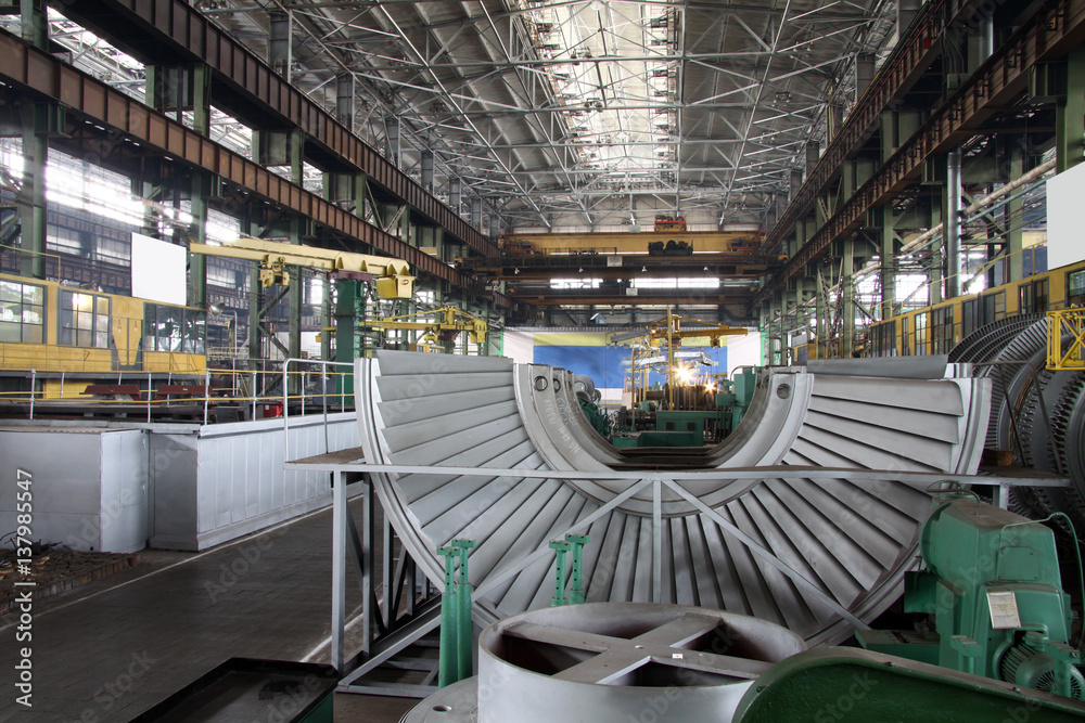 Fototapeta premium Manufacture of water turbines. The huge machine turbine production. Large parts of the plant.