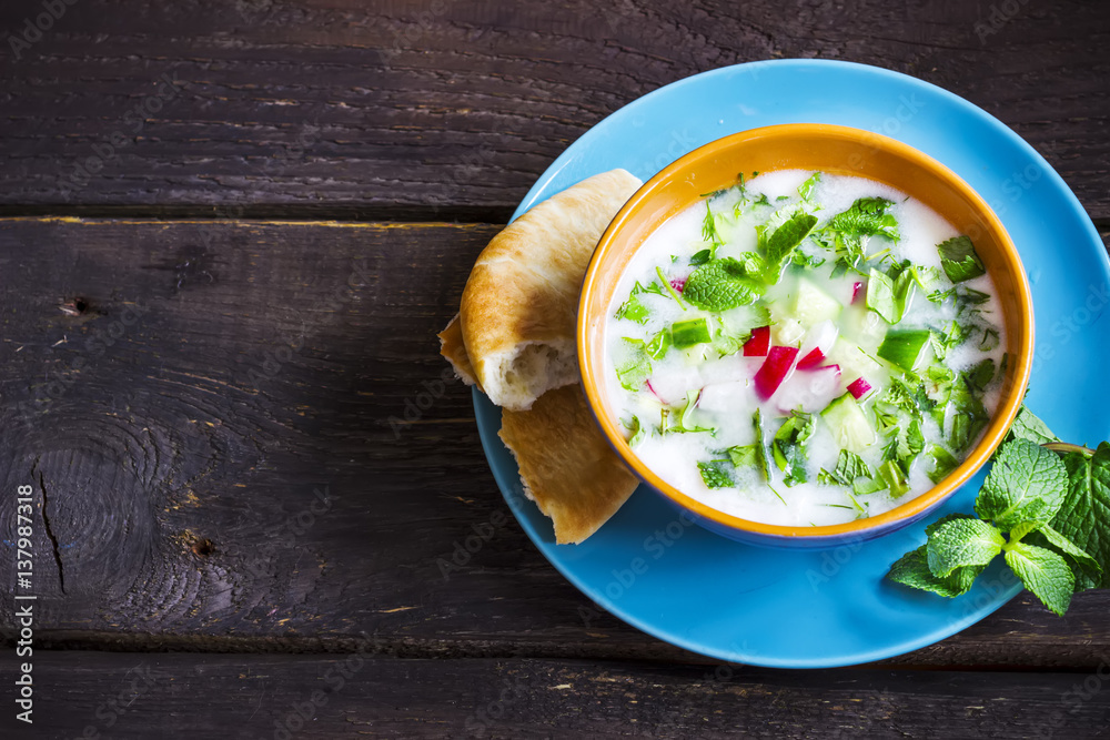 Azerbaijani/russian cold soup with greens on dark rustic background. Azerbaijani/russian cold soup with greens on dark rustic background.