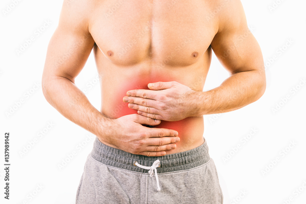 Naklejka premium Man with stomach pain over white background