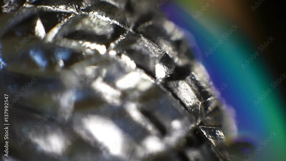 Rotating mirror glittering crystal glass surface close up