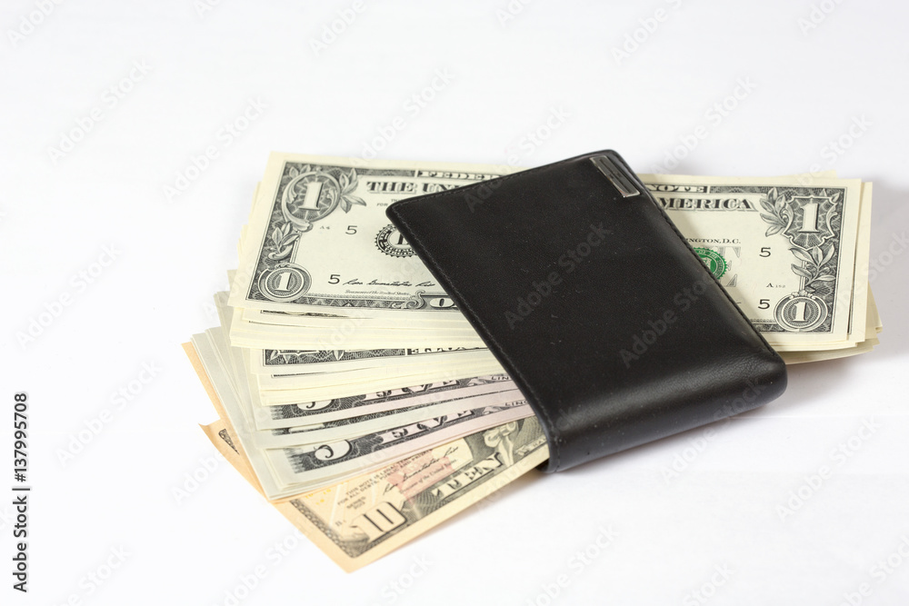 Black leather wallet left unguarded. The wallet is full of cash. US dollars coming out of it. Black leather wallet left unguarded. The wallet is full of cash. US dollars coming out of it.
