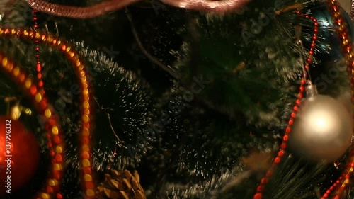 Flashing Christmas lights garland on a Christmas tree decorated with Christmas balls