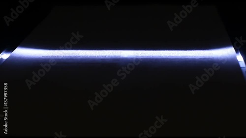 Neon photo scanner lamp moves from top to bottom