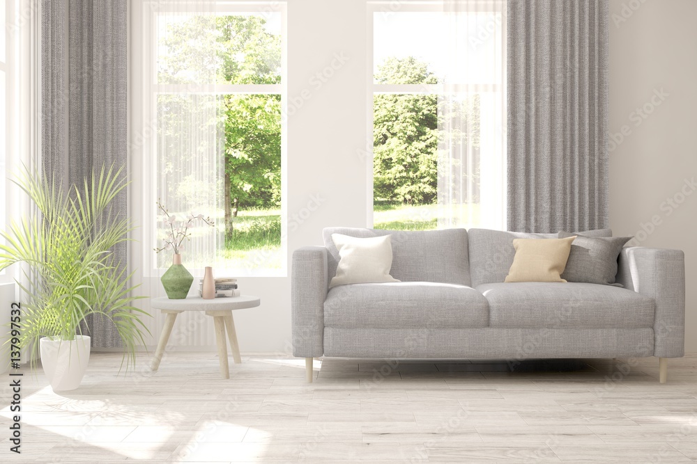 White room with sofa and green landscape in window. Scandinavian interior design White room with sofa and green landscape in window. Scandinavian interior design