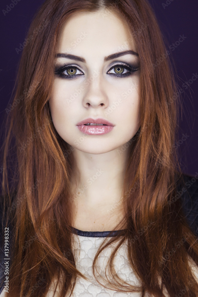 Beautiful brunette model woman in dress and with evening creative smokey make up. Looking in front of her. Clean fresh skin Beautiful brunette model woman in dress and with evening creative smokey make up. Looking in front of her. Clean fresh skin