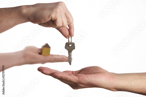 Buying a new house concept, a women and man hand holding a model home and a key put together on isolate white background.