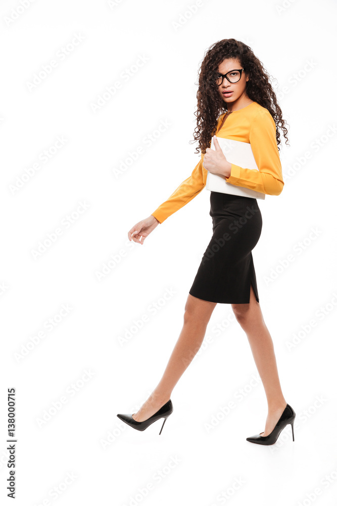 Serious young curly african lady over white background with documents Serious young curly african lady over white background with documents