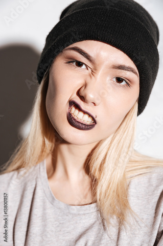Vertical image of Young Hipster woman in black hat