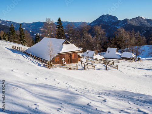 Traditional cottages on Velika planina in winter, Slovenia © erikzunec