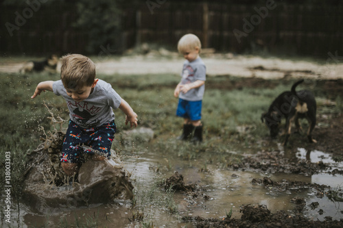 Children playing on muddy field