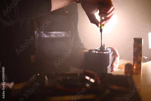 test burning the new dual coils on the atomizers deck base of electronic cigarette for vaping, close up scene photo
