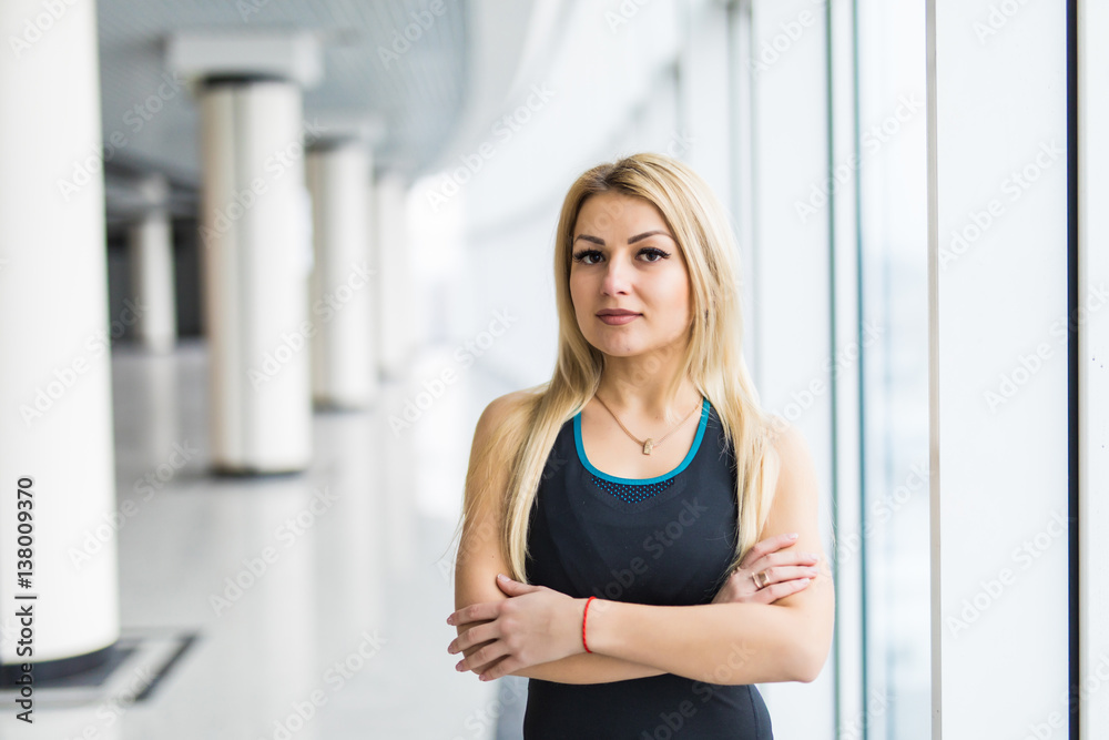 Young woman near big panaramic windows in sport wear before treaining, Young woman near big panaramic windows in sport wear before treaining,