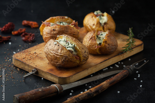 Fotografi Baked potatoes with prosciutto and cheese
