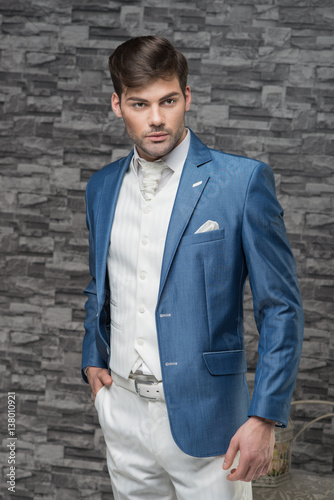 Man model in light blue jacket, white waistcoat and cravat